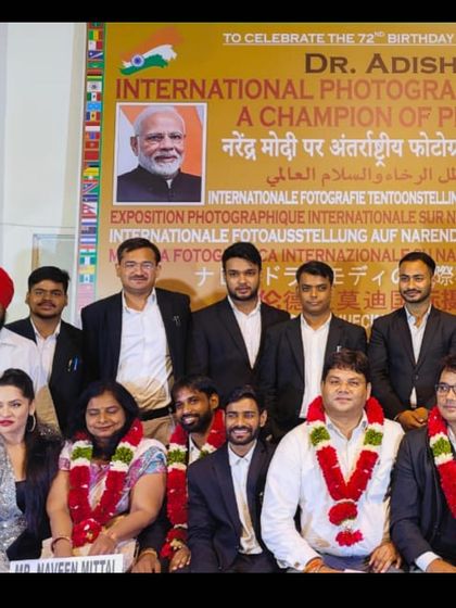 A group photograph from the International Photography Exhibition event, celebrating the work of Dr. Adish C. Aggarwala.