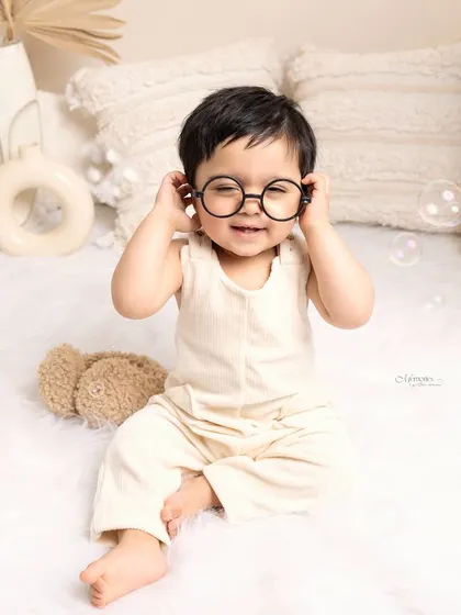 Capturing the pure, unfiltered joy of a baby's first year is so special. This playful portrait, complete with bubbles and adorable glasses, shows the fun and personality that shines in my milestone sessions.