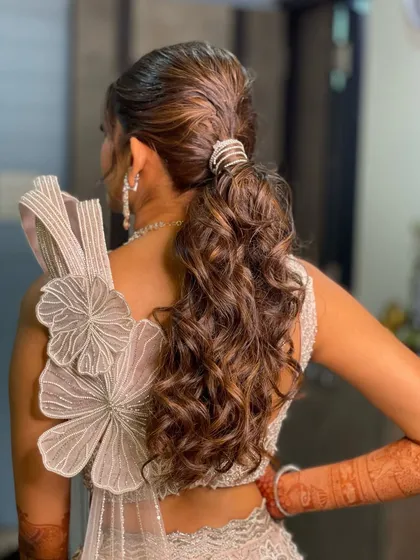 A side view of the messy, textured ponytail, showing its movement and modern appeal.