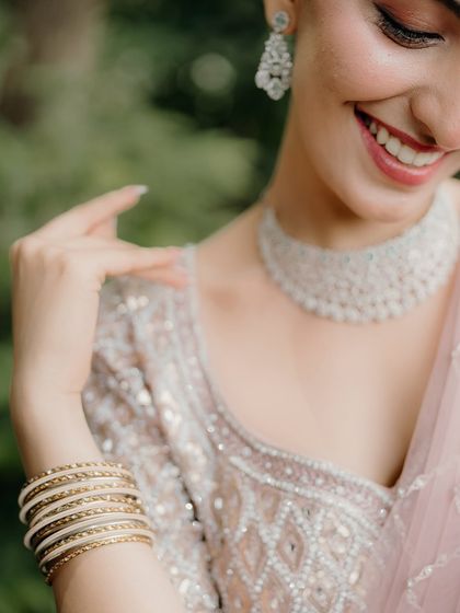 A close-up on a beautiful smile. This shot focuses on the bride's joy and the stunning details of her diamond necklace.