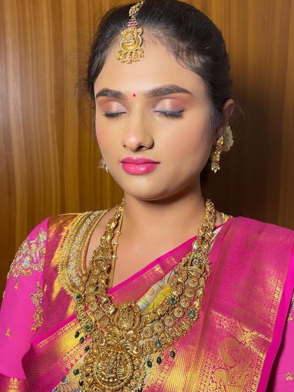 A close-up of the bridal makeup, showing the soft pink tones on the eyes and lips.