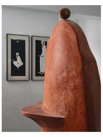 The "Melting Candle" wall serves as a sculptural backdrop for other art pieces. Here, it stands behind two beautiful paintings, creating a rich dialogue between different forms of art. It is a prime example of how we layer artistic elements to tell a deeper story.