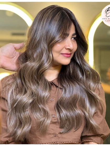 The client looking confident and beautiful with her new ash blonde hair.