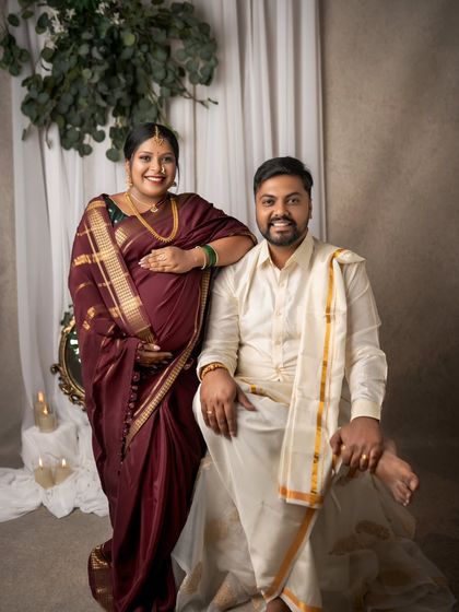 A beautiful portrait of togetherness. The couple stands proudly, their smiles reflecting the shared excitement of this special phase in their lives, captured in classic ethnic wear.