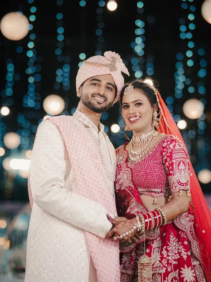 A happy couple portrait against a backdrop of beautiful bokeh lights, creating a magical and celebratory feel for their reception.