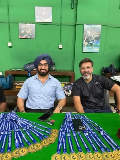 The coaches behind the scenes, getting the medals and trophies ready for the summer camp's closing ceremony.