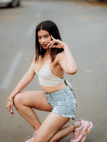 This pose adds a sense of high-fashion energy to a simple street location. It shows how direction and posing can transform a space.