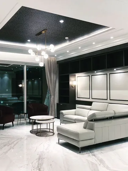 This is what happens when modern luxury meets a cozy night in. We designed this living room with a dramatic dark ceiling, marble floors, and plush seating to create a space that’s perfect for hosting or just chilling. It’s high-end without being stuffy.