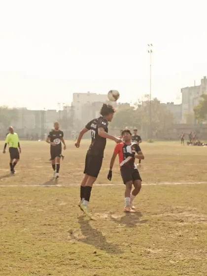 A player leaping high for a header, showcasing the athleticism and commitment we demand in every match.