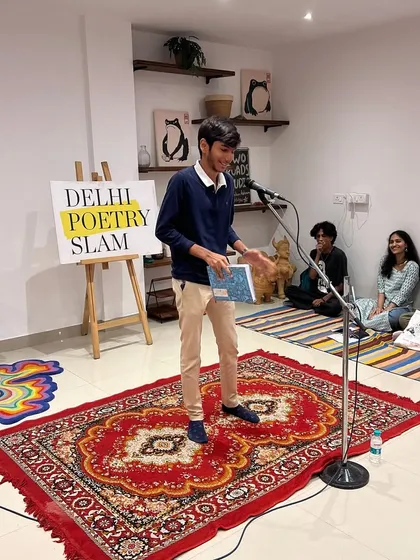 A young poet sharing his work from a book at our intimate studio event. Whether you read from a page or perform from memory, your voice is welcome here.