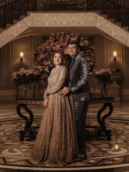 A regal portrait of Madhushree and her husband at their reception. Her makeup is elegant and timeless, with a soft glam eye and a flawless complexion that radiates sophistication.