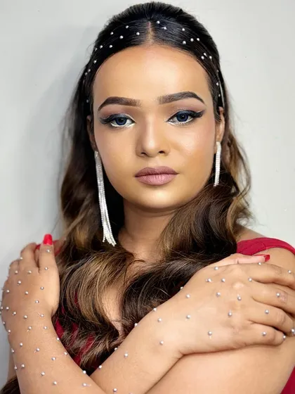 A full view of the cocktail look, with the model showing off the rhinestone-studded hands and matching hairband.