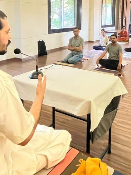 An instructor sits before a class to begin a session on Suddhi Kriya. This workshop provides both theoretical knowledge and practical experience in yogic cleansing techniques for internal purification.