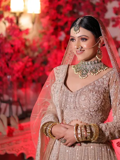A candid side-profile shot, capturing the bride's natural smile and the details of her outfit.