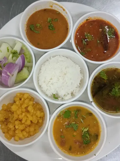 A sample of our daily corporate thali, deconstructed to show the variety. Each meal typically includes rice, dal, sambar, a vegetable side, and salad.