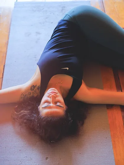 A moment of deep rest in a supine spinal twist. Restorative yoga isn't about stretching, but about releasing and allowing the body to be held.