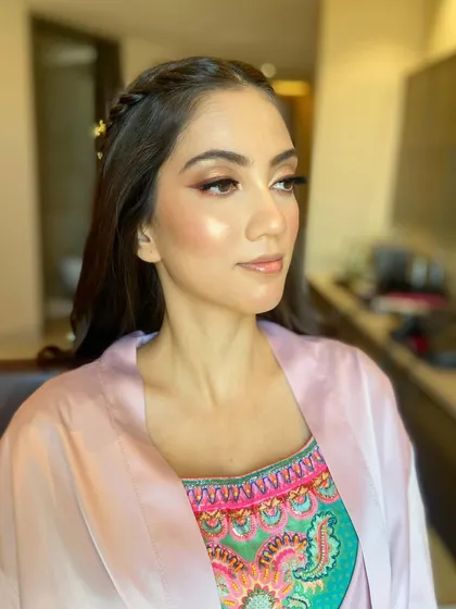 The final makeup look before the hair is done, showcasing the flawless skin and eye makeup.