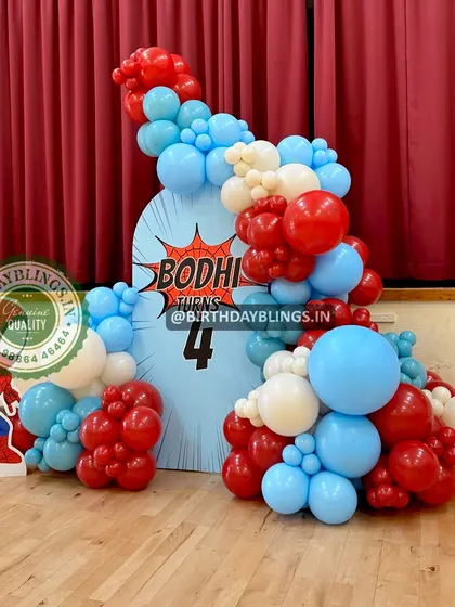 A simple and effective Spider-Man theme, with a character cutout and a balloon arch in the hero's signature colors. The backdrop features a comic-style "Bodhi turns 4" graphic.