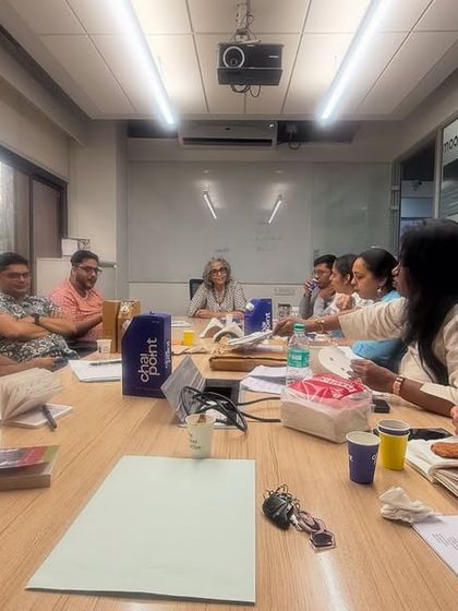 Another angle from our final 'Hamlets' session, showing the collaborative spirit of the group. Everyone is seated around the table as equals, sharing insights and learning from one another.