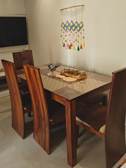 Here is the crochet sun wall hanging adding a splash of color above a dining table. It shows how a handmade piece can become a beautiful focal point in a room.