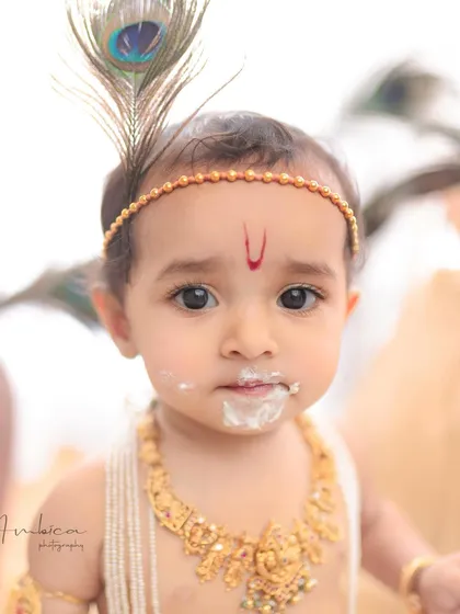 This is the art I love to create. A close-up of a mischievous little Krishna, caught with a mouthful of butter. These thematic baby portraits are more than just pictures; they are stories frozen in time.