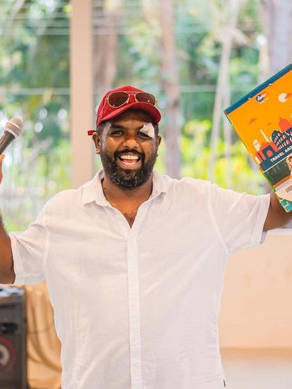 Our director holding a mic and an award, ready to announce a winner at Spectra 2023.