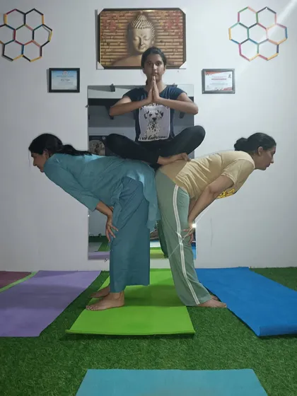This three person acro pose is great for beginners. The two bases create a stable platform for the flyer to practice a seated pose, building trust and balance.