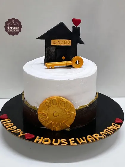 A housewarming cake to celebrate a new home. This chocolate truffle cake is topped with a fondant house and key, along with a coin for good luck.