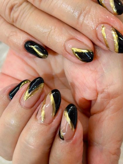 A bold and graphic design with black and gold geometric shapes on a clear base.