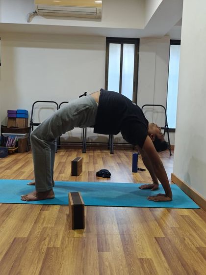 Progress in Chakrasana is measured by the feeling of openness, not just the height of the arch. This student demonstrates great shoulder and thoracic spine mobility.