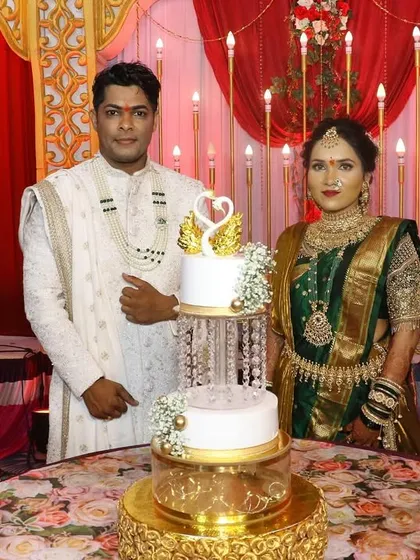 This photo captures the beautiful setup of the engagement cake on a floral-covered table, with the happy couple ready to celebrate.