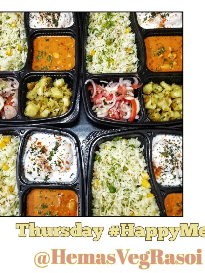 Multiple happy meals ready for a corporate delivery. This Thursday meal included corn mutter pulav, kaju masala, jeera aloo, fresh salad, and soft dahi wada.