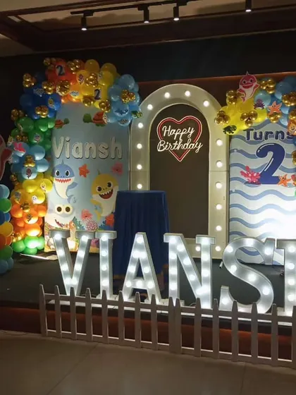 A fun-filled Baby Shark theme for a second birthday party. We created an underwater scene with character cutouts, large marquee letters for the name, and a lighted archway, making it a huge hit with the kids.