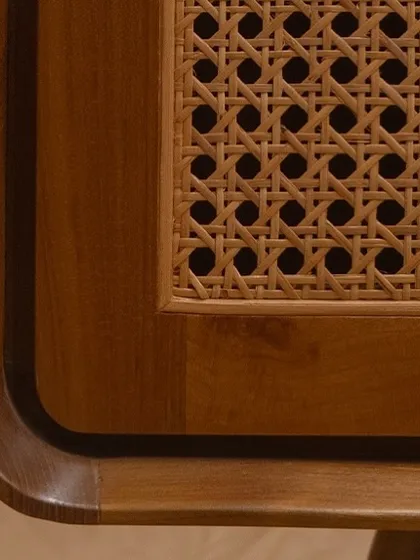 A close look at the corner of my 'Romaji' bench reveals the soul of my work. You can see the rich grain of the solid teak wood and the precision of the handwoven rattan. These are the details that ensure my furniture is not just beautiful, but enduring.