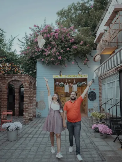 A moment of pure celebration as the couple throws a hat in the air. This playful image perfectly captures the fun and excitement of their pre-wedding journey.
