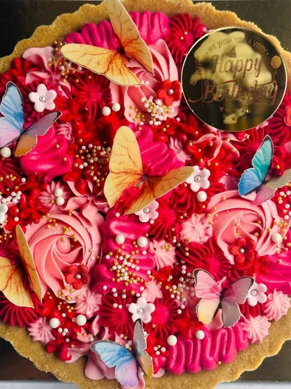 This gorgeous butterfly chocolate tart, in shades of red and pink, was a bestseller. The combination of rich colors and delicate butterflies makes it a stunning birthday centerpiece.