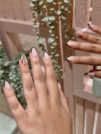 This design plays with negative space and clean lines for a French manicure that feels artistic and unique.
