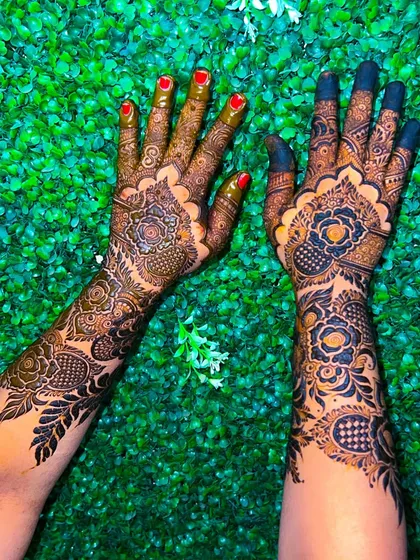 A clear top-down view of the stunning, dark floral henna design.