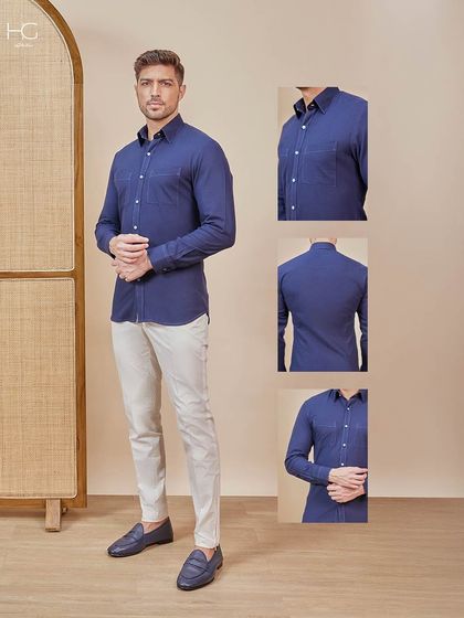 This look is subtle, refined, and undeniably premium. A classic navy shirt paired with light grey trousers and navy loafers is a masterclass in smart-casual dressing.
