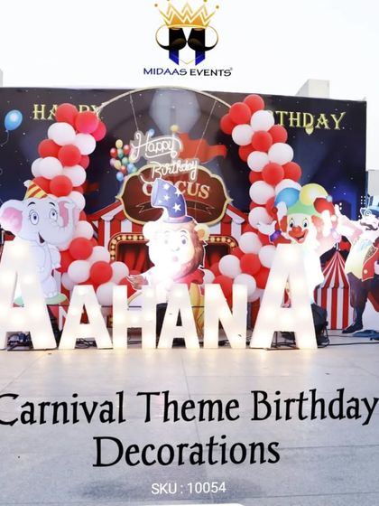 Step right up to a carnival-themed birthday party. This fun setup includes marquee letters for the name, a circus-tent backdrop, and cutouts of circus animals and characters.