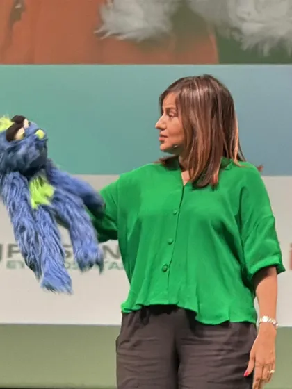 A close-up shot with one of my puppets during a keynote speech. They are not just for comedy shows; they also help make my corporate talks more engaging and memorable.