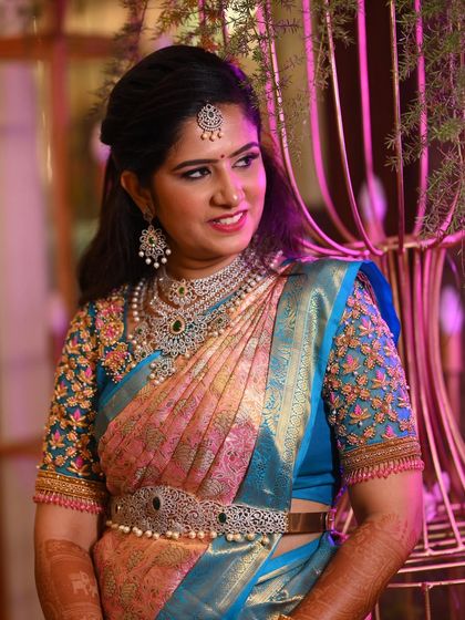 Rashmi's elegant side profile, showcasing her half-up hairstyle and the stunning details of her diamond jewellery.