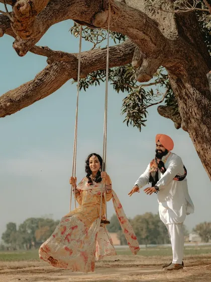 A playful push on a rustic swing, capturing the simple joys and timeless traditions of love. This shoot in a Punjabi village setting shows how we can weave cultural elements into your story.