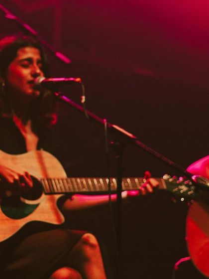 A candid moment of me singing with my guitarist during our trio set.