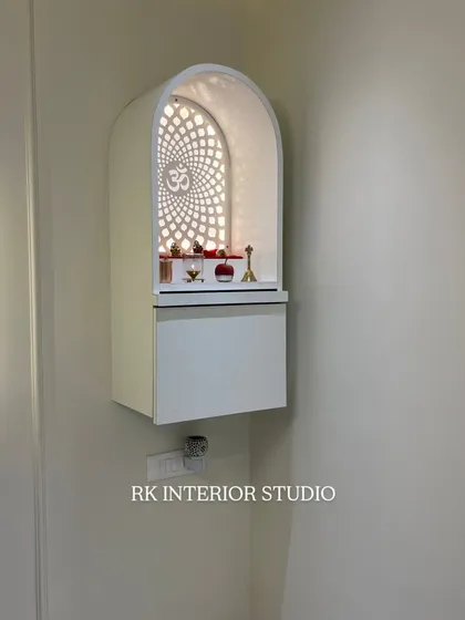 A modern, wall-mounted mandir with a beautiful backlit "Om" jaali. This compact design is perfect for apartments, providing a divine corner without taking up any floor space.