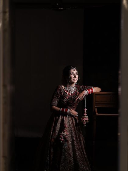 A full-length shot capturing the grandeur of the bridal lehenga and the elegance of her overall look.