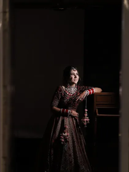 A full-length shot capturing the grandeur of the bridal lehenga and the elegance of her overall look.