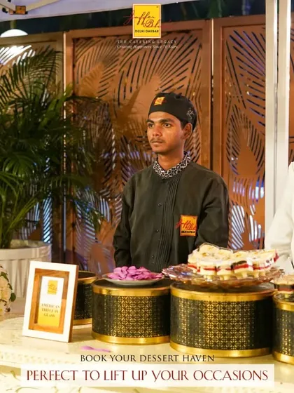 Book your dessert haven to lift up your occasions. A beautiful three-tiered wedding cake is the centerpiece of this elegant dessert station.