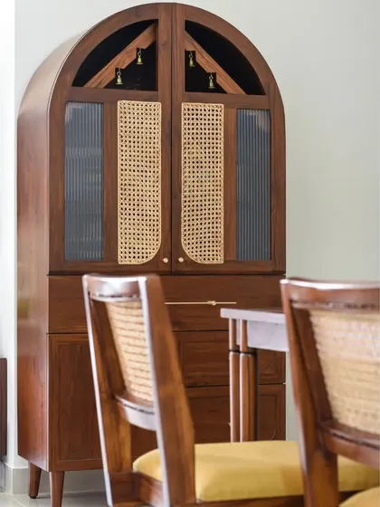 The Bagh collection, featuring a tall unit customized as a Pooja cupboard and a statement dining table with eight unconventional legs and brass accents. This shows how we can adapt our designs for different functional and aesthetic needs.