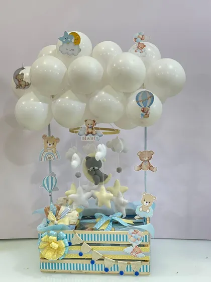 The full view of the teddy bear themed hamper, complete with a cloud of white balloons, creates the illusion of a hot air balloon. It’s a whimsical and imaginative gift for a newborn.